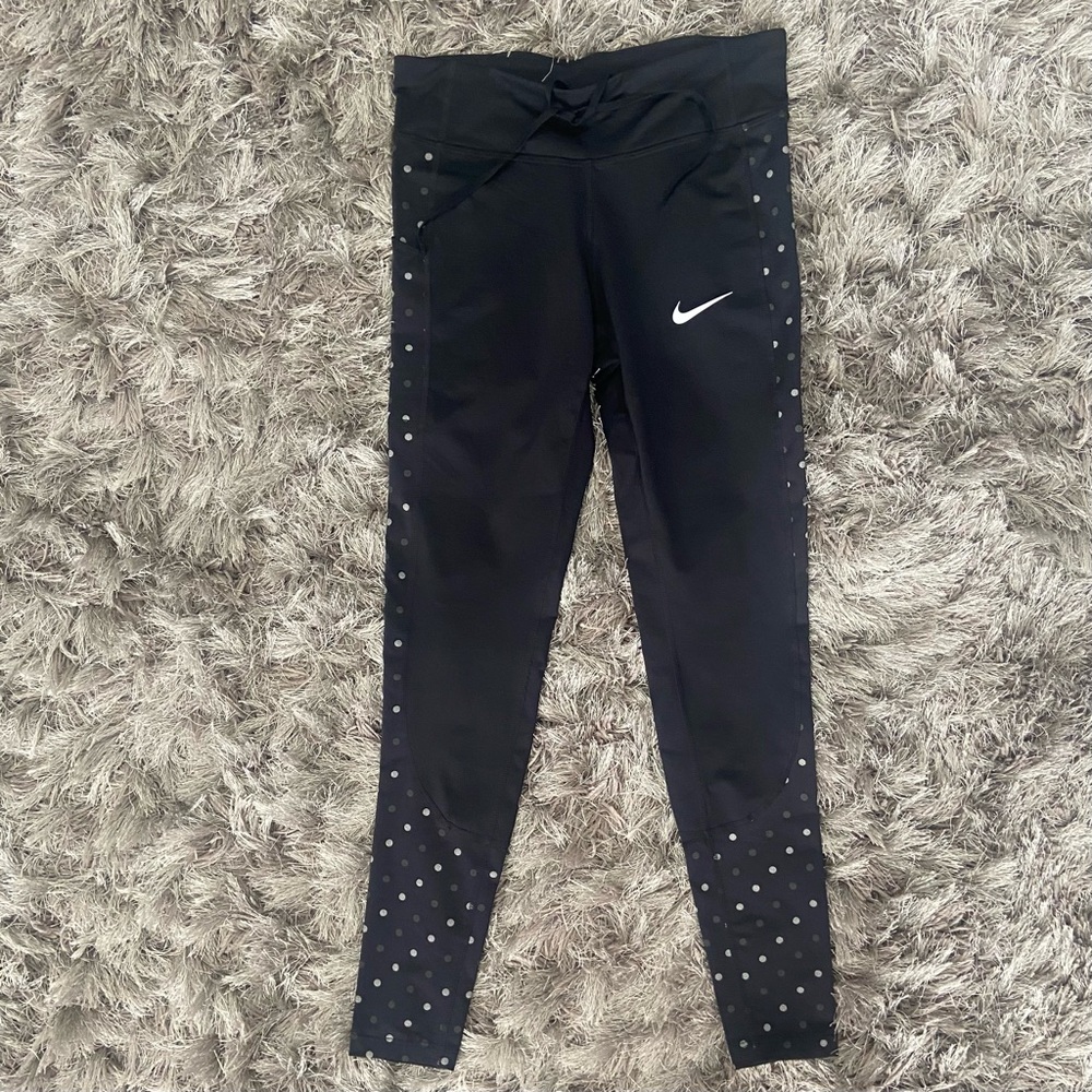 Nike Dri fit women black with dots Swoosh logo, side pocket leggings. Size S.